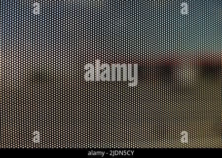 Mesh texture on glass. Shooting window. Small cage. Textured surface. Stock Photo