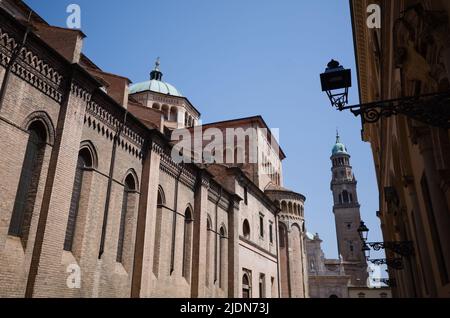 Side wall of Parma Cathedral and bell tower of Church of San Giovanni Evangelista also known as Abbazia di San Giovanni Evangelista. Vintage lanterns Stock Photo