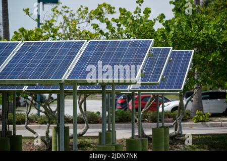 Solar panels installed on stand frame near parking lot for effective generation of clean electricity. Photovoltaic technology integrated in urban Stock Photo