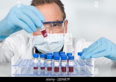 close-up of a scientist working with blood test tubes in a laboratory Stock Photo