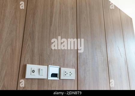 Power outlet on wooden Wall Background Stock Photo