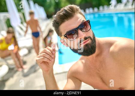 Male vacationer taking a selfie at the resort Stock Photo