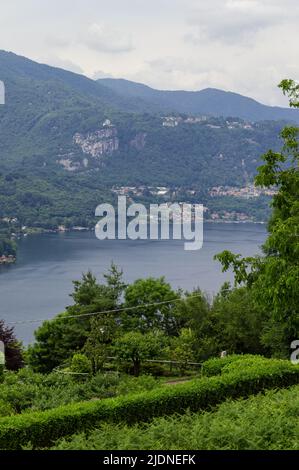 Landscape view of the Orta lake seen from a hiking path closed to its coast, in the picture the little island San Giulio is visible Stock Photo