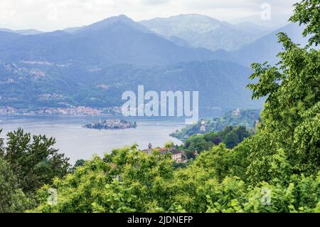 Landscape view of the Orta lake seen from a hiking path closed to its coast, in the picture the little island San Giulio is visible Stock Photo