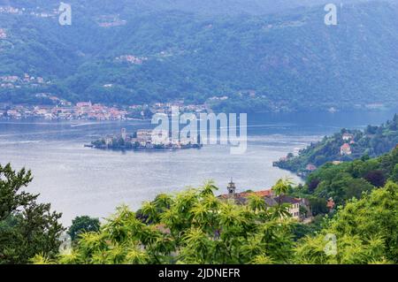 Landscape view of the Orta lake seen from a hiking path closed to its coast, in the picture the little island San Giulio is visible Stock Photo