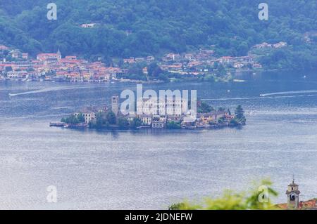 Landscape view of the Orta lake seen from a hiking path closed to its coast, in the picture the little island San Giulio is visible Stock Photo