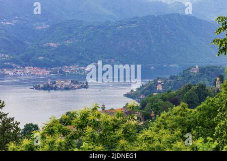 Landscape view of the Orta lake seen from a hiking path closed to its coast, in the picture the little island San Giulio is visible Stock Photo