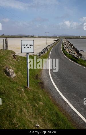 A designated passing place on the narrow causeway road between the adjoining islands of North and South Uist in the Outer Hebrides Stock Photo