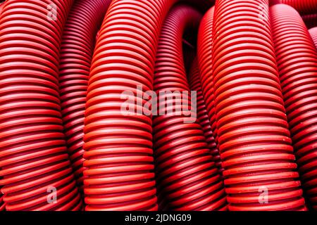 red corrugated pvc pipe for underground electrical cable laying Stock Photo