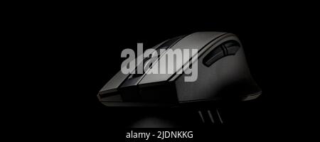 Black computer mouse on a black background.Mouse for PC filmed on a black background Stock Photo
