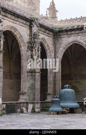 Spain, Santiago de Compostela, Galicia. Bells of the Cathedral of Santiago de Compostela Sitting in Cloister Courtyard. Stock Photo