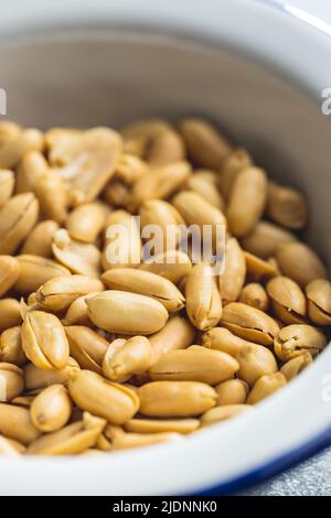 Roasted peeled peanuts in a bowl. Stock Photo
