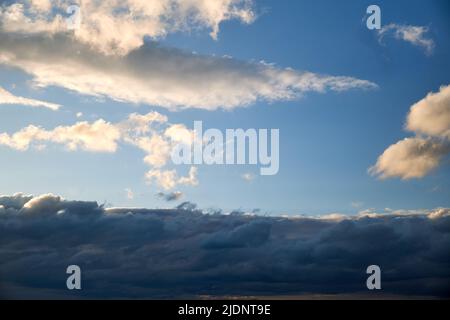 Dark rain clouds in the evening sky. Dramatic sky with an coming cloudy cyclone of bad weather Stock Photo