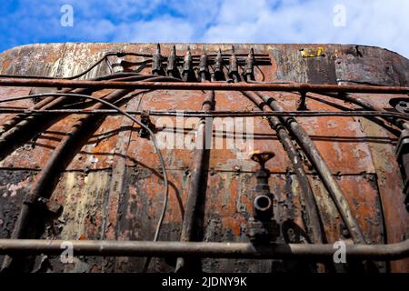 Details of steam locomotive standing outside of historic locomotive shed. The shot was taken in natural lighting conditions Stock Photo