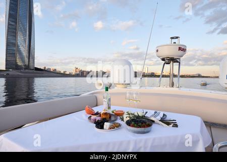 Table set with food on upper deck of yacht Stock Photo