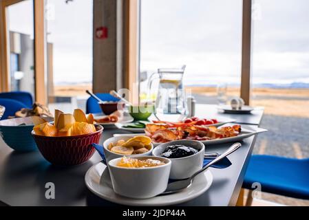 Healthy breakfast served on dining table against window with view at restaurant Stock Photo