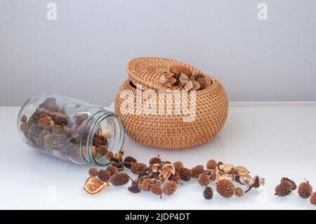 wicker straw box craft round on top with dried flowers and lavender on a white background Stock Photo