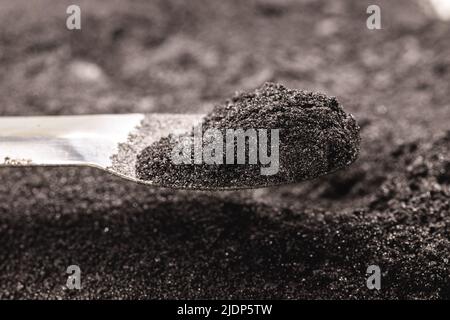 Cobalt Powder Coarse Mesh 99.9 High Fluid Cobalt Metal, on isolated white background, industrial use black powder, industrial pigment Stock Photo