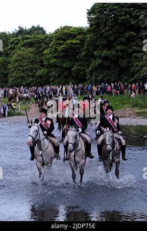 Peebles, UK. , . Beltane Wednesday - Cornets Installation, Rideout & Reel Peebles Cornet Iain Mitchell carries the flag on the traditional riding of the Marches. Flanked by his left and right hand men, fording the river Tweed. ( Credit: Rob Gray/Alamy Live News Stock Photo