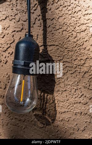 outdoor LED light against a stucco wall Stock Photo