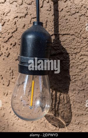 outdoor LED light against a stucco wall Stock Photo
