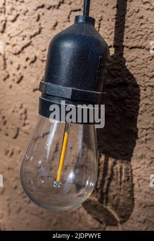outdoor LED light against a stucco wall Stock Photo