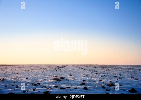 Picture of a typical winter landscape, a rural agricultural field covered with snow and ice in the region of Banat, in Serbia, in Europe. Stock Photo