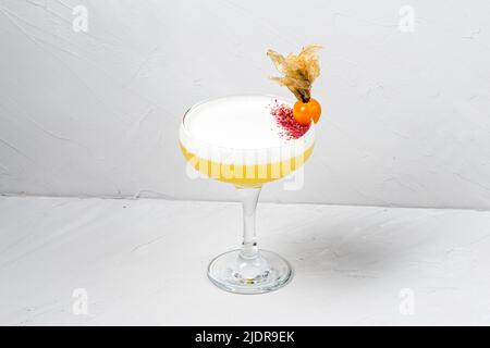 Glass of fresh whiskey sour cocktail on white Stock Photo