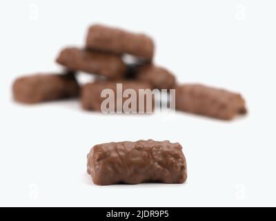 Crispy bits of chocolate bars. Chocolate bars with peanuts and caramel. Selective focus. Close up view.
