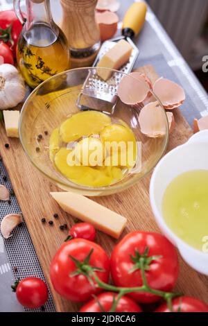 Ingredients for making homemade pasta carbonara - egg yolks in glass bowl Stock Photo