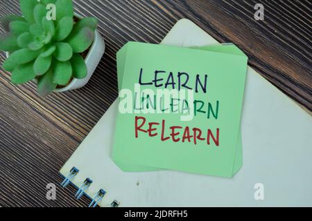 Concept of Learn, Unlearn, Relearn Continuous Learning write on sticky notes isolated on Wooden Table. Stock Photo
