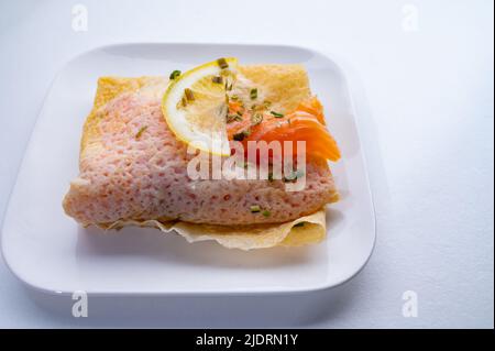 Cuisine of Normandy, galette pancake filled with goat cheese and smoked salmon served with fresh lemon, France Stock Photo