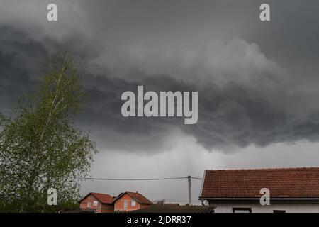 Storm clouds above suburbs, dark clouds in neighbourhood Stock Photo