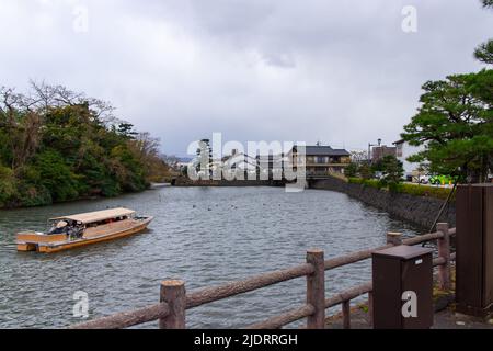 Matsue, Shimane, JAPAN - Dec 1 2021 : A sightseeing boat going down the Horikawa river near Matsue Castle at evening. Stock Photo