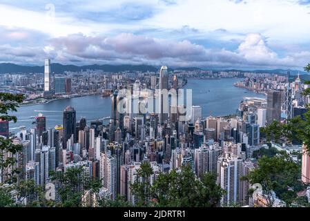 The evening view of Victoria Harbour in Hong Kong, as seen from Victoria Peak, with the skyscrapers of Central in the foreground. Stock Photo