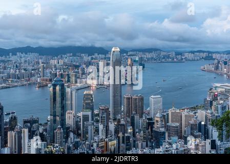 The evening view of Victoria Harbour in Hong Kong, as seen from Victoria Peak, with the skyscrapers of Central in the foreground. Stock Photo