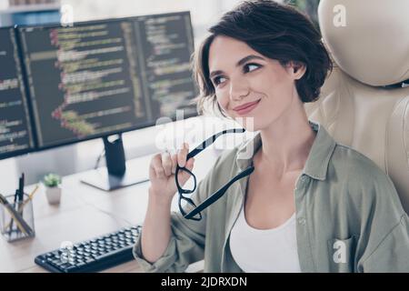 Portrait of attractive experienced smart clever cheery minded girl technician solving task thinking at work place space indoors Stock Photo