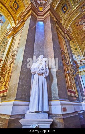 BUDAPEST, HUNGARY - FEB 27, 2022: The white sculpture of St Anthony of Padua, holding Baby Jesus, St Stephen's Cathedral, on Feb 27 in Budapest Stock Photo