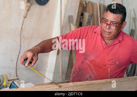 Elderly carpenter working at his workshop. Stock Photo