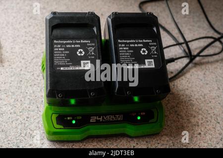 Two 24V Li-Ion Lawnmower batteries on charge. Stock Photo