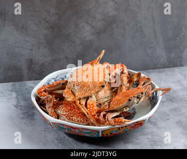 Streamed Blue Crabs Sand Crab, Popular as Flower Crab. Served on Ceramic Plate, Copy Space for Text Stock Photo