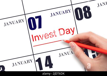 7th day of January. Hand drawing red line and writing the text Invest Day on calendar date January 7. Business and financial concept. Winter month, da Stock Photo