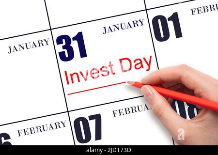 31st day of January. Hand drawing red line and writing the text Invest Day on calendar date January 31. Business and financial concept. Winter month, Stock Photo