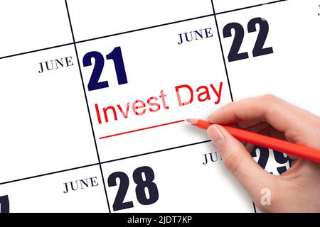 21st day of June. Hand drawing red line and writing the text Invest Day on calendar date June 21. Business and financial concept. Summer month, day of Stock Photo