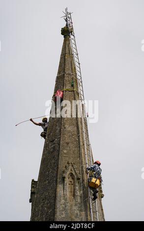 Arthur Needham (right), a conservator from Vitruvius Building Conservartion, climbs the steeple of St Mary's Church in Uffculme, Devon.Picture date: Thursday June 23, 2022. Stock Photo