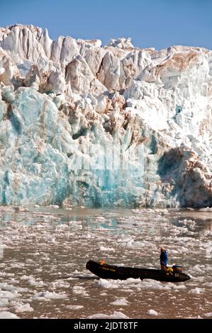 Zodiac and driver in front of the stunning King's Glacier in King's Fjord, western Spitsbergen, Svalbard Stock Photo