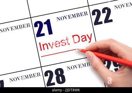 21st day of November. Hand drawing red line and writing the text Invest Day on calendar date November 21. Business and financial concept. Autumn month Stock Photo