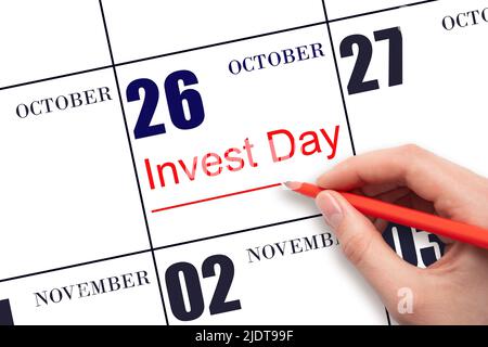 26th day of October. Hand drawing red line and writing the text Invest Day on calendar date October 26. Business and financial concept. Autumn month, Stock Photo