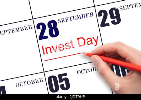 28th day of September. Hand drawing red line and writing the text Invest Day on calendar date September 28. Business and financial concept. Autumn mon Stock Photo