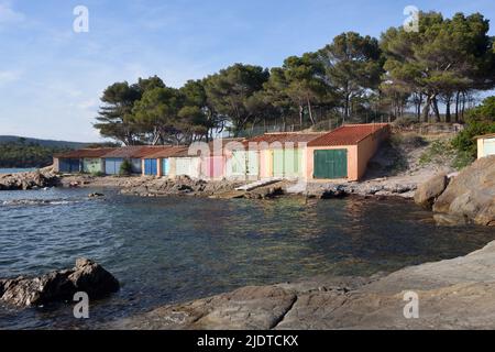 Colourful Old Boatsheds on the Shore near the Beach or Plage de Bregançon opposite Bregançon Fort & Island Bormes-les-Mimosas Var Provence france Stock Photo